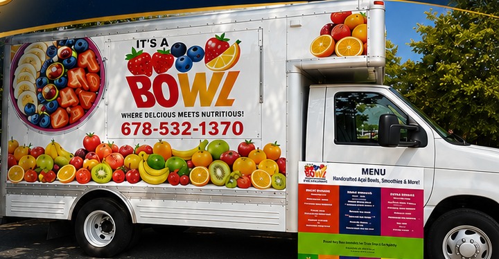 The actual It's A Bowl white food truck with its colorful fruit branding and menu board